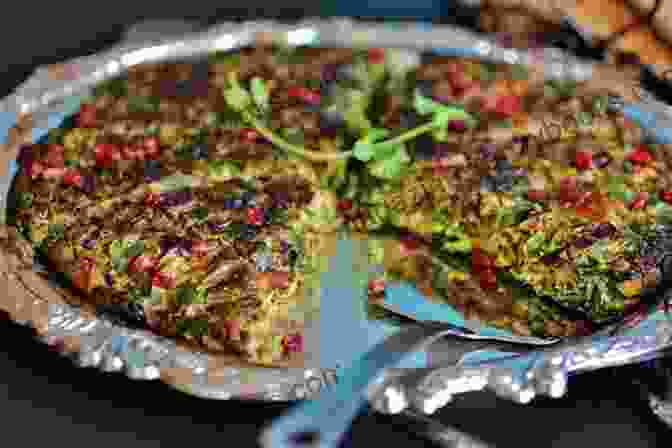 A Golden Brown Kookoo Sabzi Garnished With Fresh Herbs And Pomegranate Seeds KOOKOO SABZI RECIPE: Persian Herb Omelette