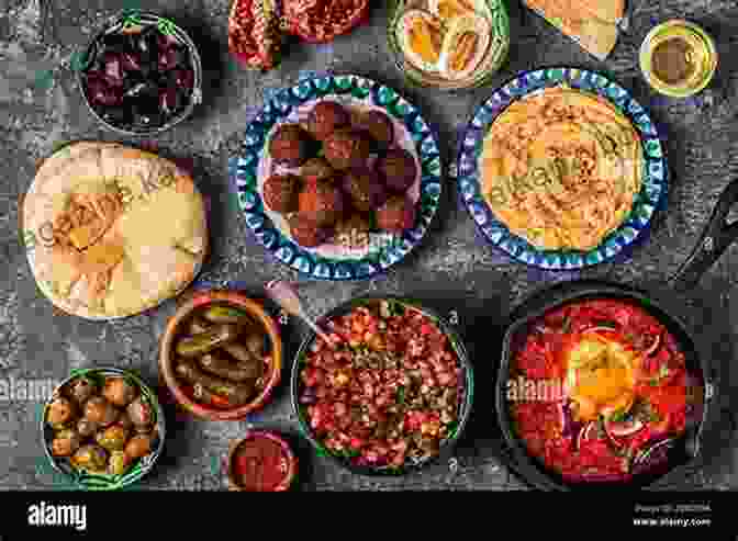 A Table Laden With Delicious Israeli Dishes, Including Hummus, Falafel, Shakshuka, And Baba Ganoush Make Authentic Israeli Dishes: A Guide To Make Your Own Israeli Dishes