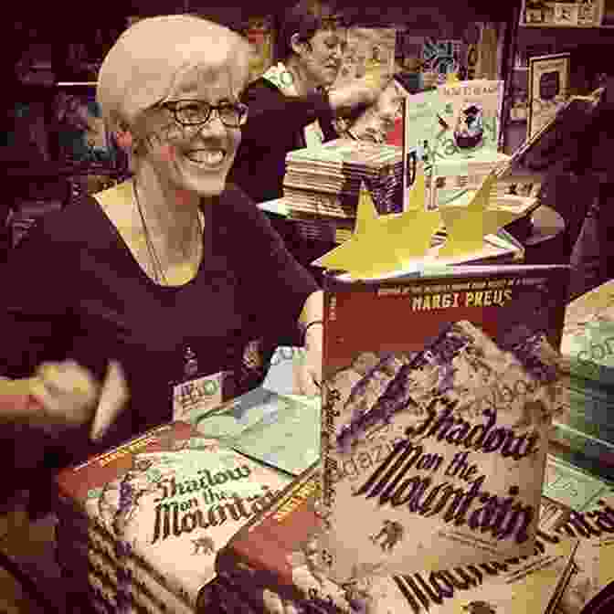 Author Margi Preus Smiling At The Camera, Surrounded By Books. Shadow On The Mountain Margi Preus